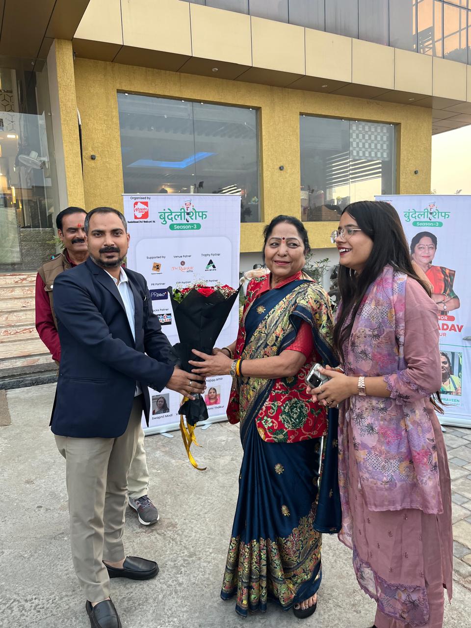 Guest being felicitated with a bouquet during a Bundeli Chef event